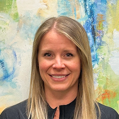 Jaime Darling Smiling In Front Of Watercolor Wall