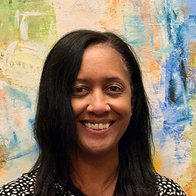 Vanessa Moar Smiling In Front Of Watercolor Wall